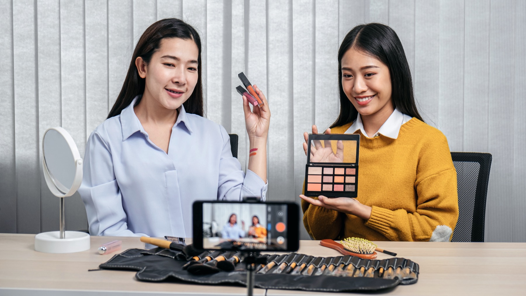 Two beauty professionals presenting products